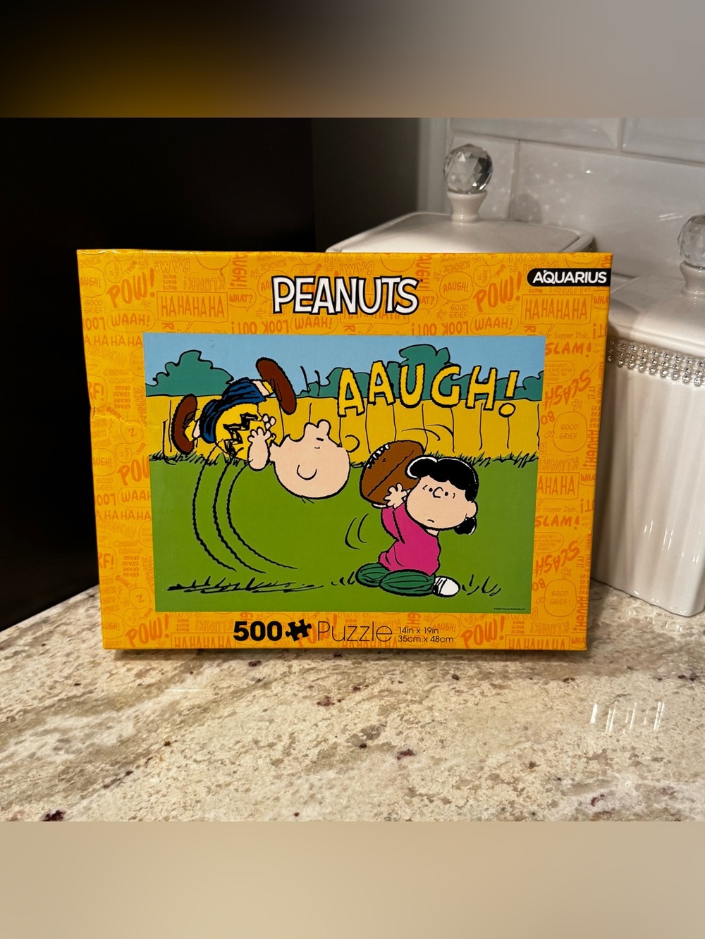 Peanuts Puzzle with Yellow Orange Box and Green Illustration
